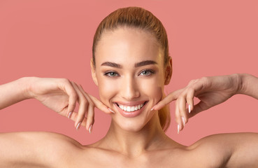 Pretty Girl Smiling To Camera Touching Face Posing In Studio