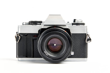 front view of a Classic analog 35 mm camera vintage and analog film rolls on white background - Powered by Adobe