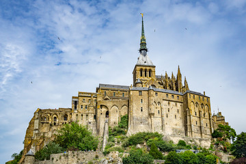 Looking up to Mont Saint Michel Abbey, famous Normandy landmark, France.