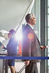 Portrait of Mature businessman boarding on the plane in airport