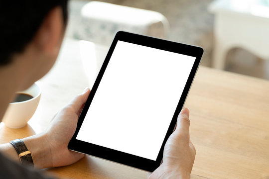 Mockup image of a man holding black color tablet device
