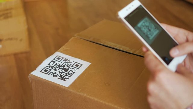 Scanning QR code with smart phone. The man reads the bar code using the application on the smartphone.