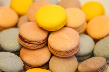 Obraz na płótnie Canvas French macaroons cookies set with different flavors. Holidays food concept. Background formed with stacked colorful macarons stock photo. Sweets. Stock photo