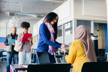 Volunteer helping citizen at polling place