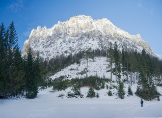 Man walking near Green lake (Gruner see) in sunny day. Famous tourist destination for walking and trekking in Styria region, Austria