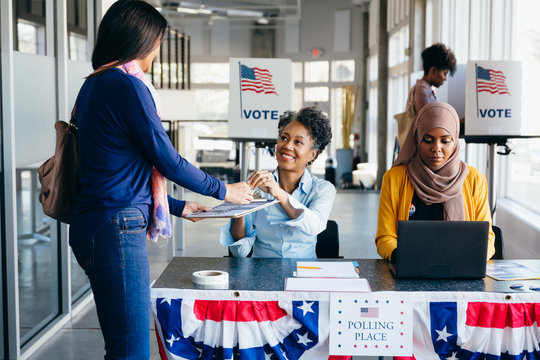 Volunteer helping citizen at polling place