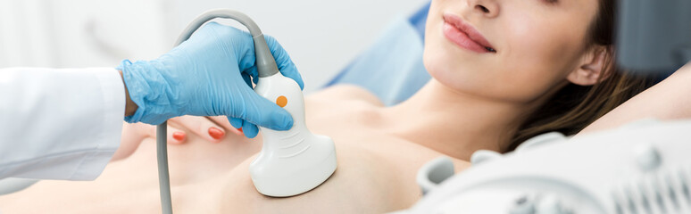 panoramic shot of doctor making breast examination for patient using ultrasound scanner