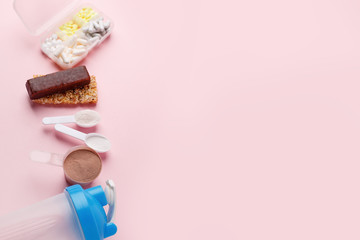 Protein powder, scoop, energetic musli bars, vitamin pills, gainer, shaker on pink background - concept of sport diet, healthcare, nutrition fit fitness food, copyspace