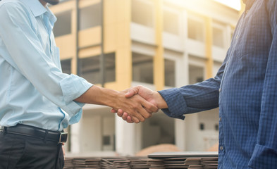 Contractor shake hand agreement success work at estate building construction site