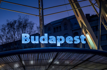 Fototapeta premium Budapest sign at blue hour on Budapest Eye ferris wheel