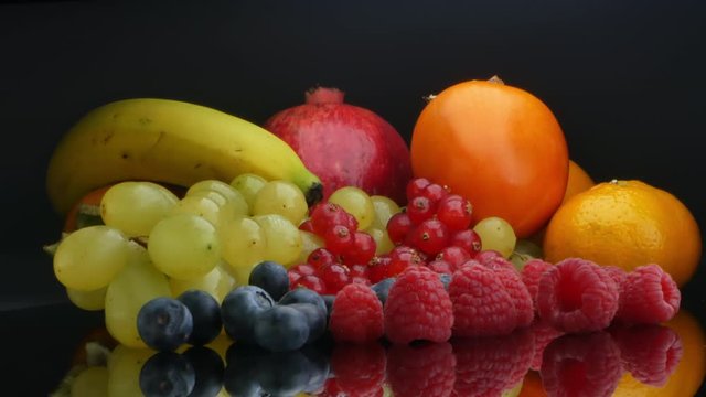 Fruit still life laid out on a black table, vitamins for the body