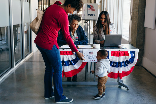Volunteer helping citizen at polling place