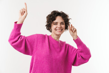 Image of happy beautiful woman pointing finger upward and dancing