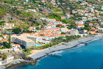 Sprawling city at the water's edge. Santa Cruz, Madeira - obrazy, fototapety, plakaty