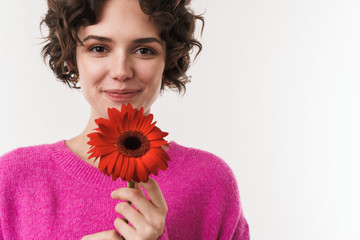 Image of cheerful beautiful woman smiling and holding flower