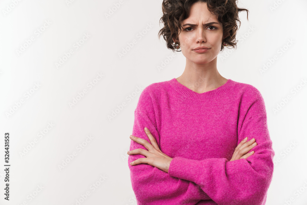 Poster Image of displeased brunette woman posing with arms crossed