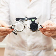 ophthalmologist doctor in exam optician laboratory with female patient. Eye care medical...