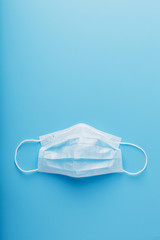 Medical mask on a blue background. Disposable face masks for viruses. Free space.
