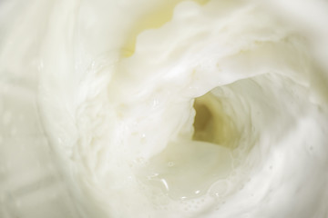 Fototapeta na wymiar Splashes of liquid milk with foam and bubbles is macro