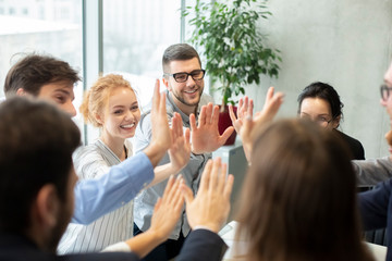 Team inspiration concept. Colleagues giving high five