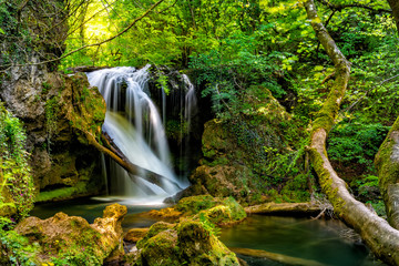 Long exposure of the beautiful La Vaioaga waterfall with green moss, Beusnita, Cheile Nerei National Park, Caras Severin, Romania