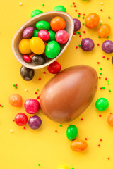 chocolate egg and candy easter decor, menu concept background. top view. copy spaces