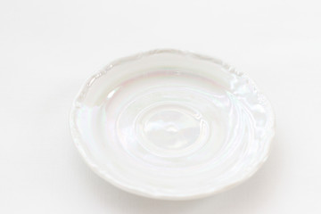 white mother-of-pearl biscuit saucer from a kitchen set on a white background