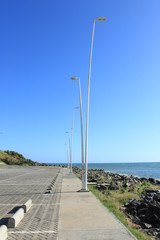Street lamps with infinite blue sky in the background