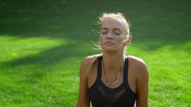 woman with prosthetic leg doing yoga in park. Girl stretching body outdoors