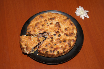 Cottage cheese casserole on a black plate with flowers.