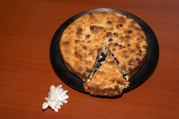 Cottage cheese casserole on a black plate with flowers.