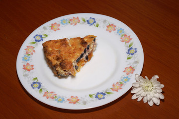 Serving cottage cheese casserole on a plate with flowers.