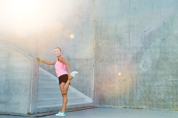 Portrait of young attractive woman stretching her legs