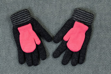 Baby pink mittens. The concept of family care and joy