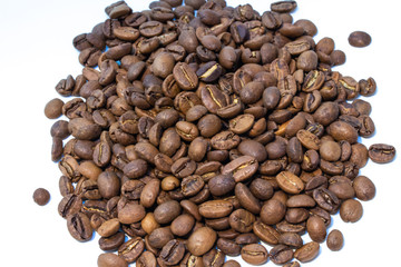 Roasted coffee beans pile isolated on white background.