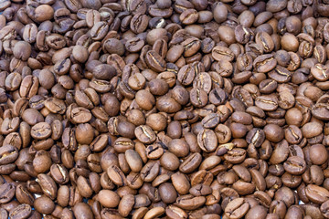 Texture of brown roasted coffee beans pile