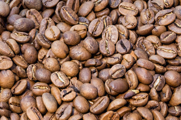 Texture of brown roasted coffee beans pile