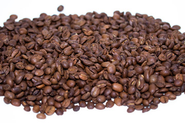 Roasted coffee beans pile isolated on white background. Selective focus.