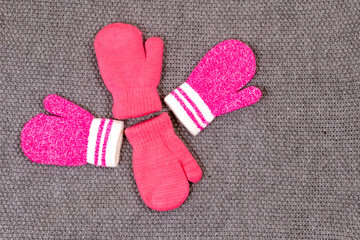 Baby pink mittens. The concept of family care and joy