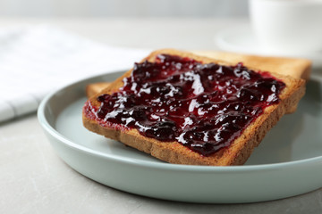 Delicious crispy toasts with jam on table, closeup