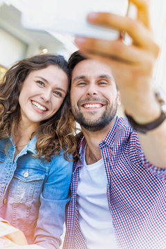 Portrait of man taking selfie with his beautiful girlfriend