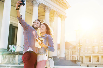 Portrait of young attractive man taking selfie with his girlfriend