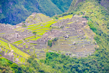 Inca city ruins of Machu Picchu on the high green hill in Peru