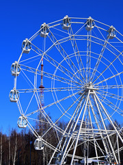 Ferris wheel in a city park on a winter sunny day