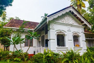 exterior of an old Villa hotel with white walls in tropical garden, Asia, Sri Lanka