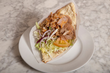 Donner kebab served on plate on marble table. Typical Istanbul food