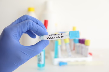 covid-19 coronavirus flu test tube with vaccine in biotechnology research laboratory