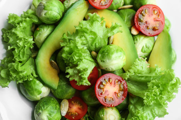 Tasty salad with Brussels sprouts on plate, top view