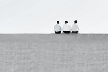 Obraz premium Black and white photo of mature thoughtful businessmen sitting on office rooftop