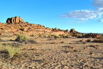Beautiful african landscape with rocks, clumps of grass, round giant stones, Namibia.